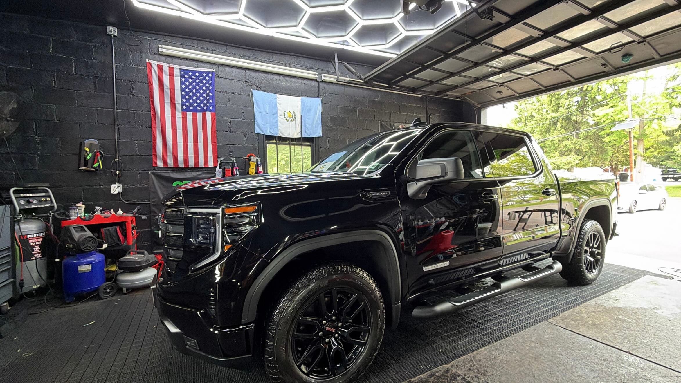 Black GMC Sierra after a full detail in the Piscataway shop bay