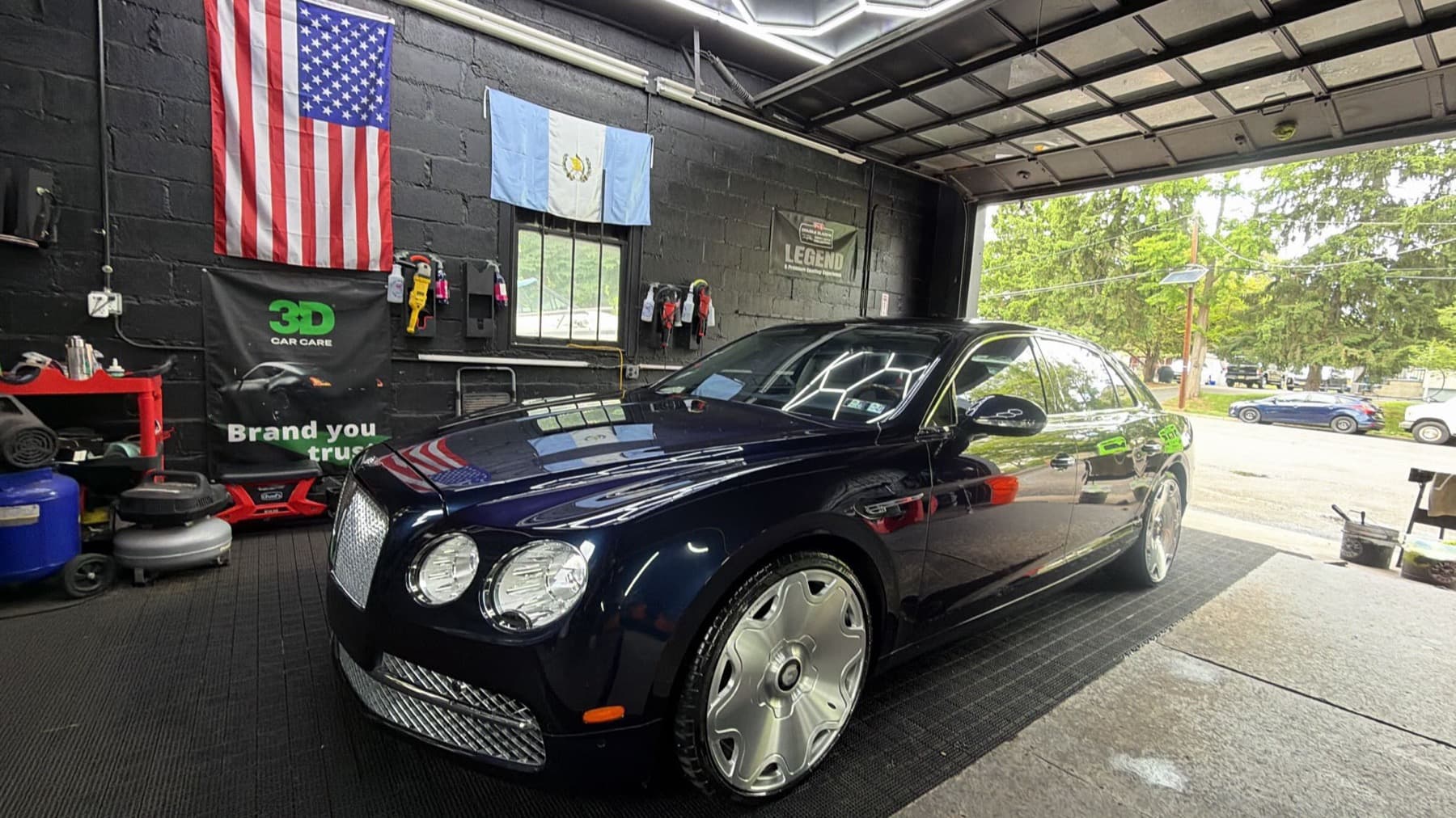 Dark blue Bentley Flying Spur fresh out of a full detail